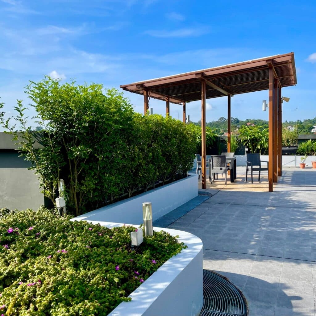 Rooftop terrace with garden beds, pavilions, and panoramic views, designed for relaxation and al fresco dining