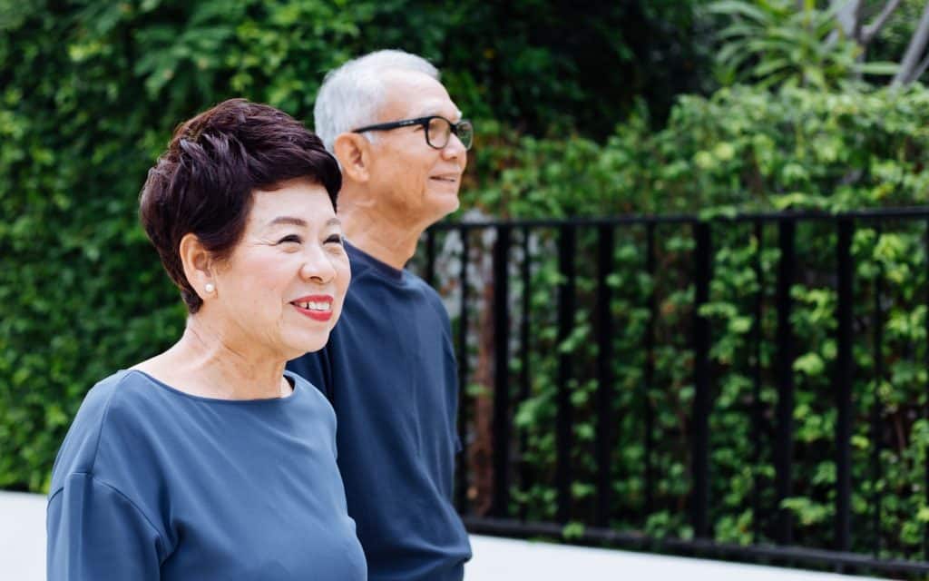 Smiling elderly resident engaged in a meaningful activity, reflecting personalized care and inspired living