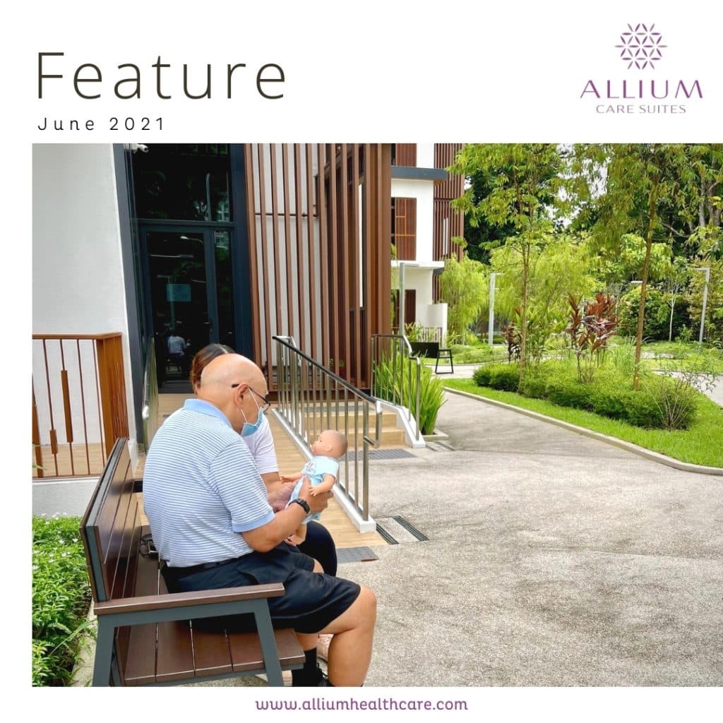 Senior gently holding a doll, offering comfort and emotional connection, often used in dementia care