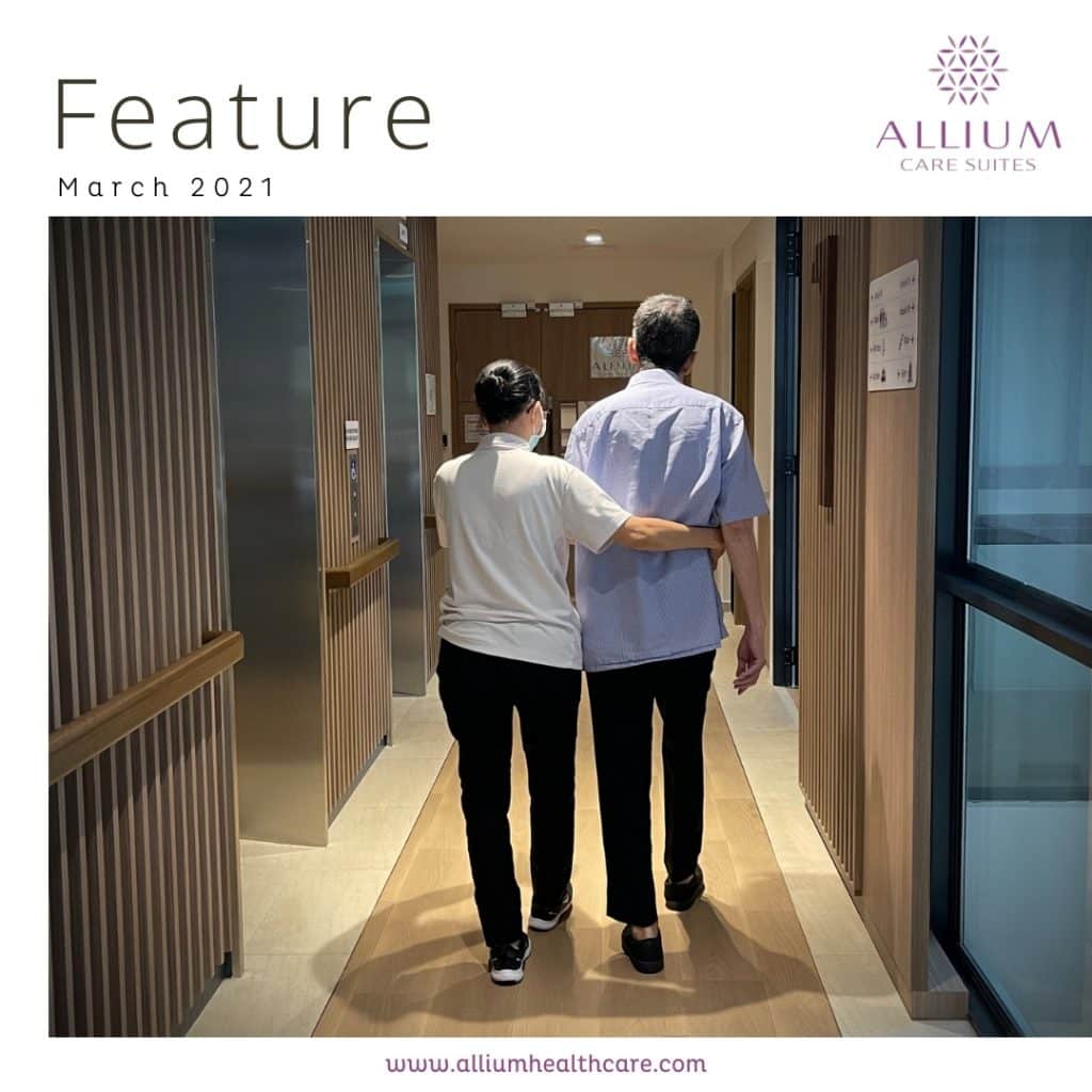 Caregiver holding a senior's waist to provide support during assisted movement