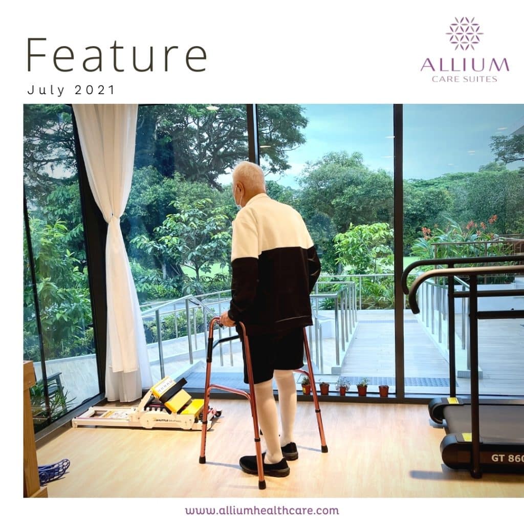 Senior practicing walking with support from a therapist, symbolizing progress in rehabilitation