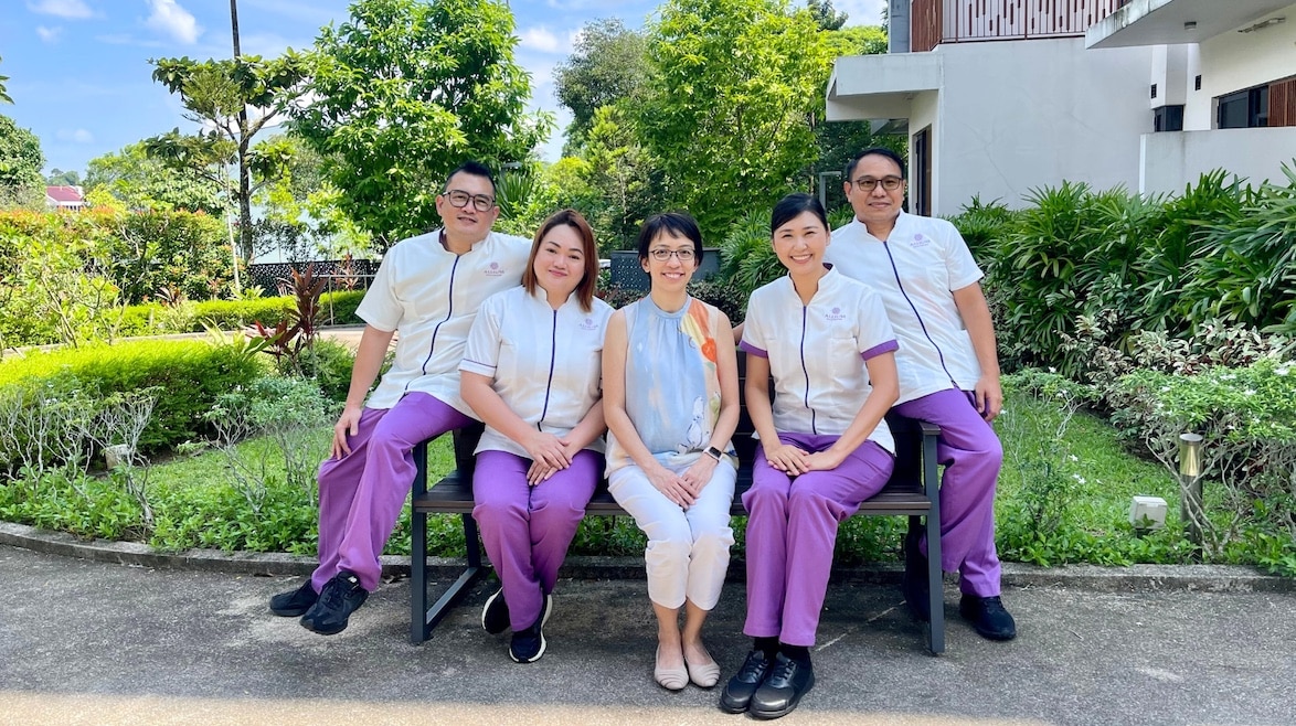 Nurse and Care Concierge interacting with a resident in a modern clinical setting, reflecting attentive, personalized care