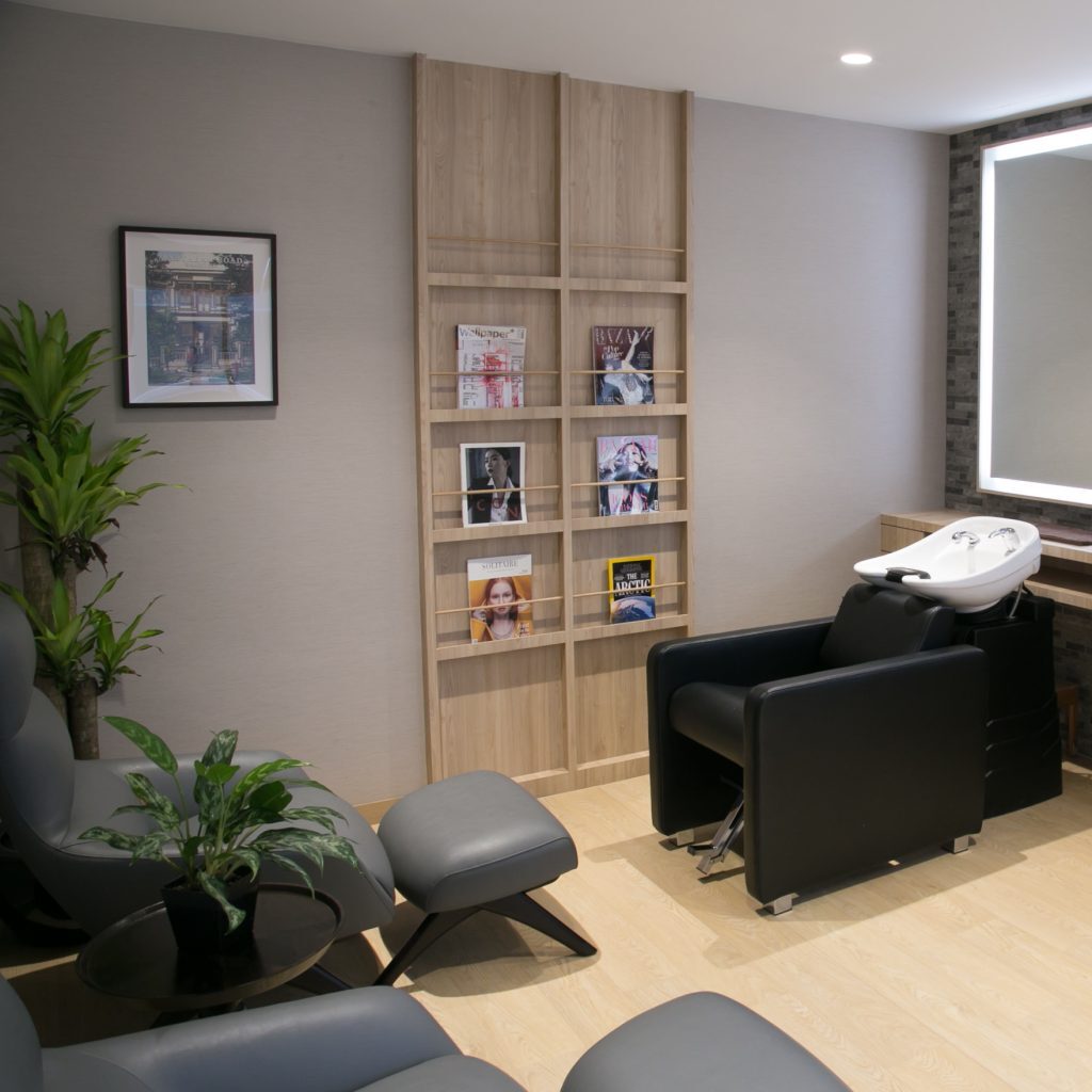 Resident receiving a hair or beauty treatment in a private, well-appointed salon