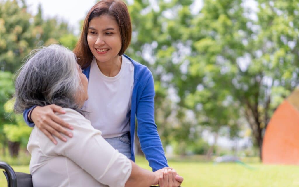 Home care professional assisting an older adult in a home setting, offering support and companionship