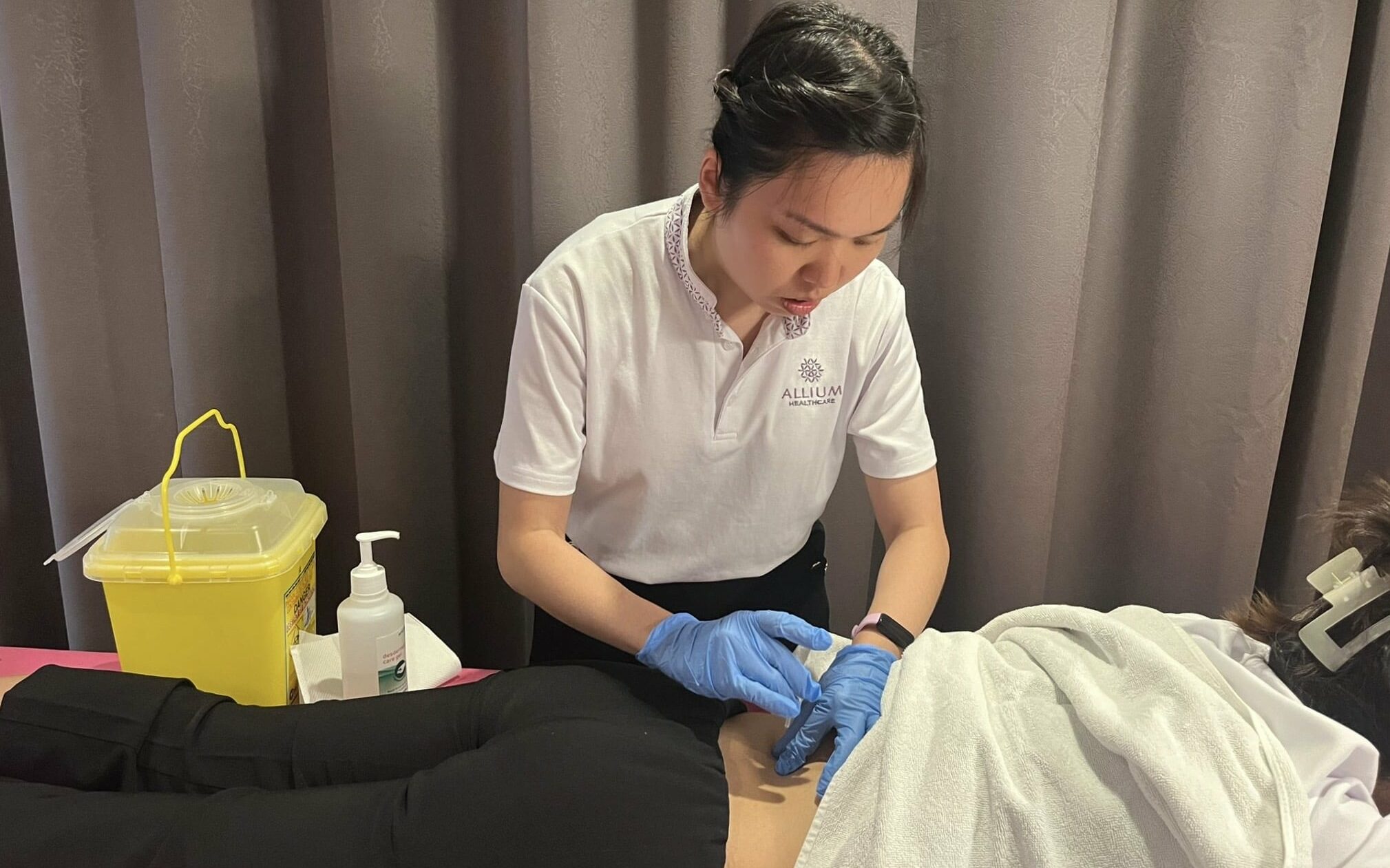 Therapist assisting a senior with musculoskeletal rehabilitation exercises to restore joint and muscle function